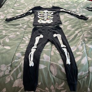 Kids size 5T glow in the dark skeleton pajamas.